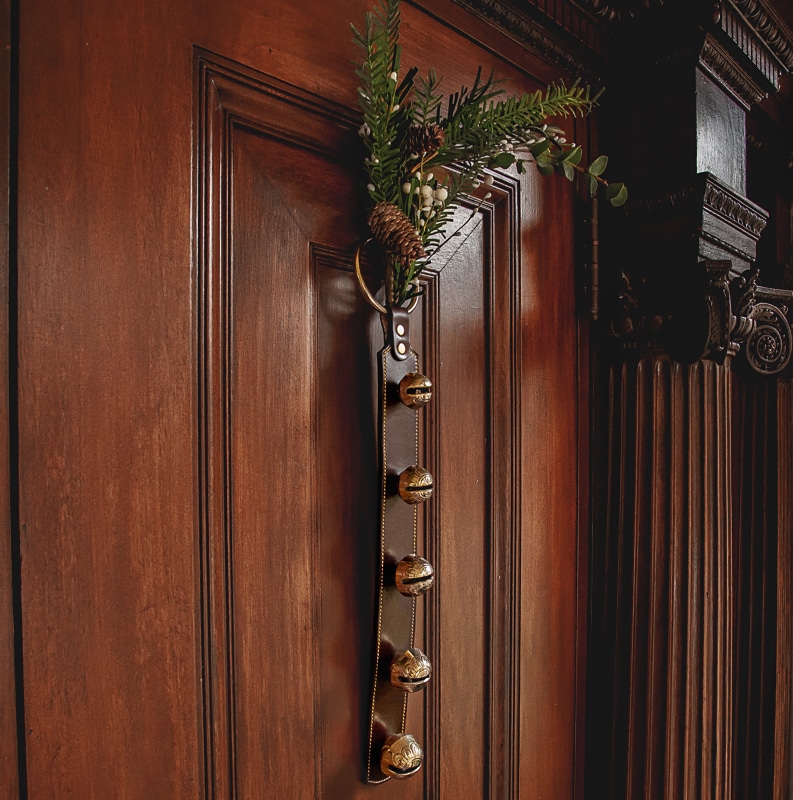 Brown leather sleigh bells to hand on door