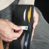 Man using Black bifold wallet that holds credit cards