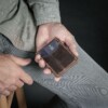 Man holding minimalist vintage brown wallet