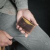 man holding handcrafted small wallet