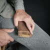 Man holding handmade vintage brown leather trifold wallet