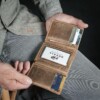 man holding handcrafted vintage brown geniuine leather wallet