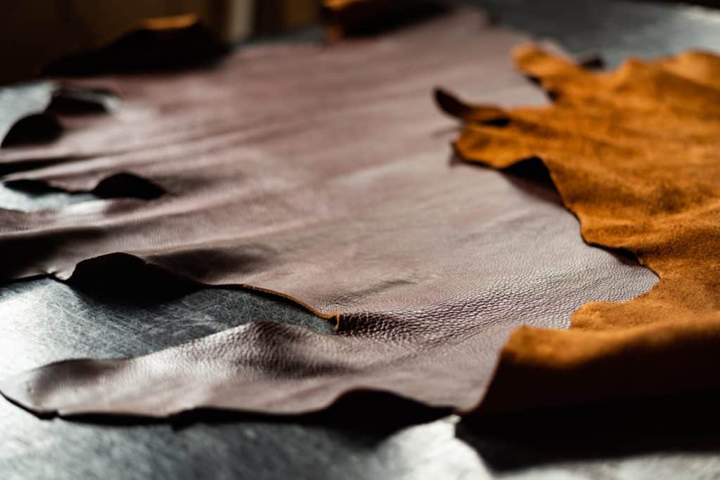 leather hides laid out across a table