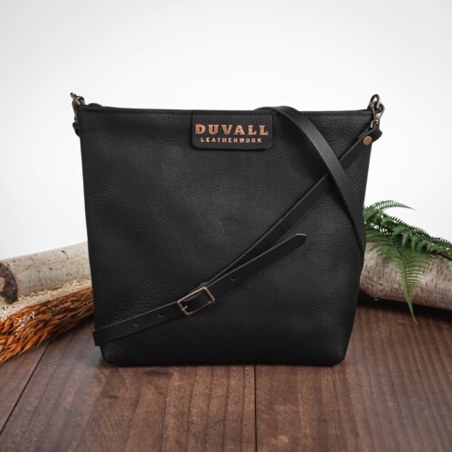 Black purse with adjustable body strap