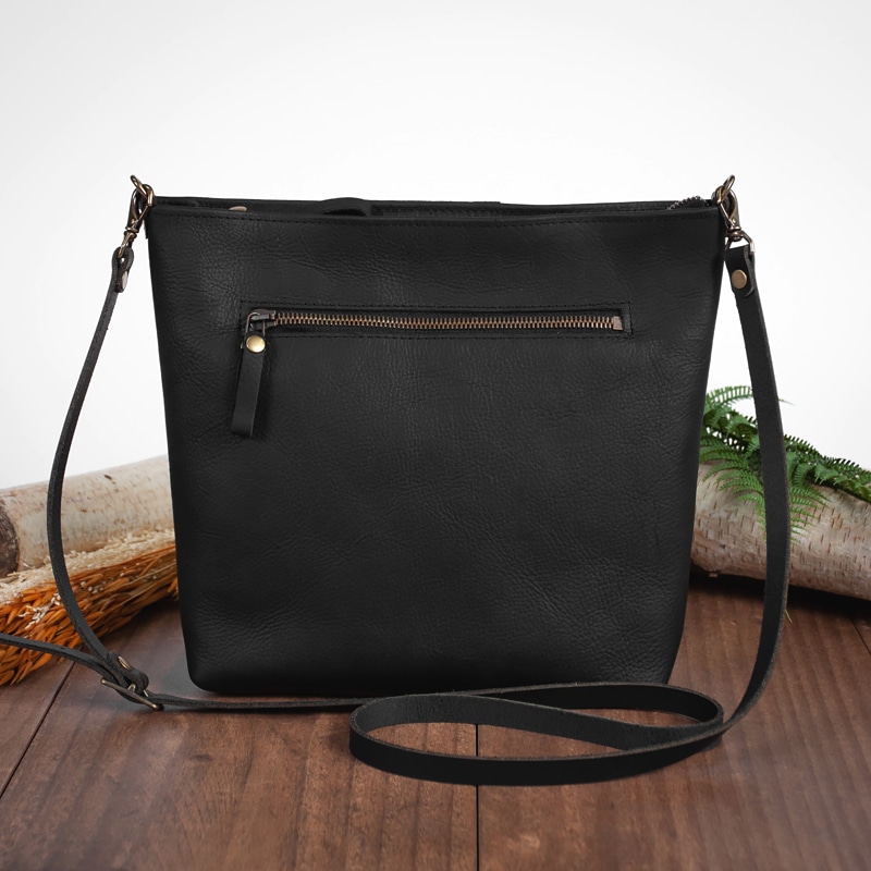 Black leather crossbody purse with adjustable strap and outside zipper pocket
