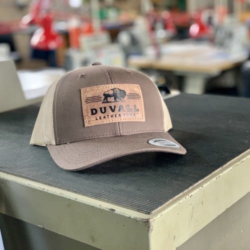 Brown trucker hat with leather buffalo logo patch