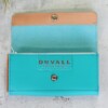 Women's turquoise leather wallet with the front flap open to show the Duvall logo and beige trim