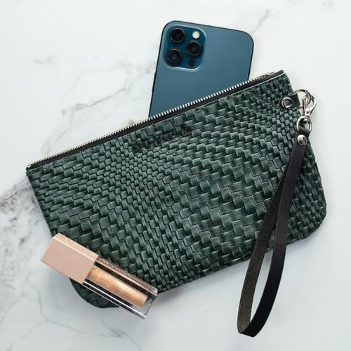 Green woven textured leather wristlet with blue iPhone and sparkle lip gloss.