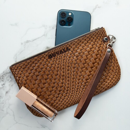 A brown woven textured wristlet with a blue iPhone and a sparkle lip gloss