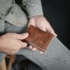 man holding beautiful handcrafted trifold bison wallet