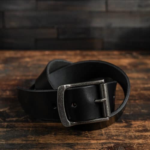 A black leather belt with an antique nickel belt buckle for men