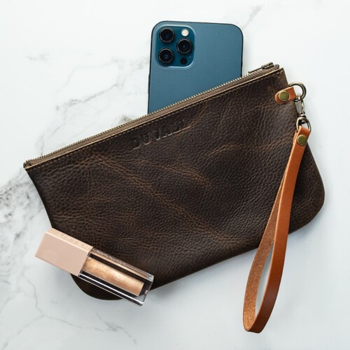 Olive green leather wristlet with blue iPhone and sparkle lip gloss