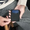 Man holding America made black leather wallet