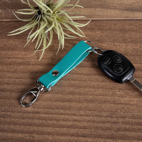 leather key fob with car key attached in turquoise