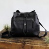 Women's leather purse backpack with a drawstring top and zippered pockets