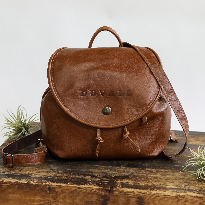 Brown leather backpack purse used by women as a handbag