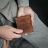 Man holding bison bifold with ID window wallet