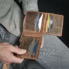 Open bifold wallet holding many credit cards