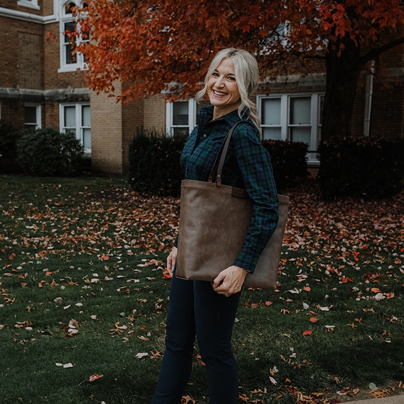 Woman walking with extra large tote bag on a fall day