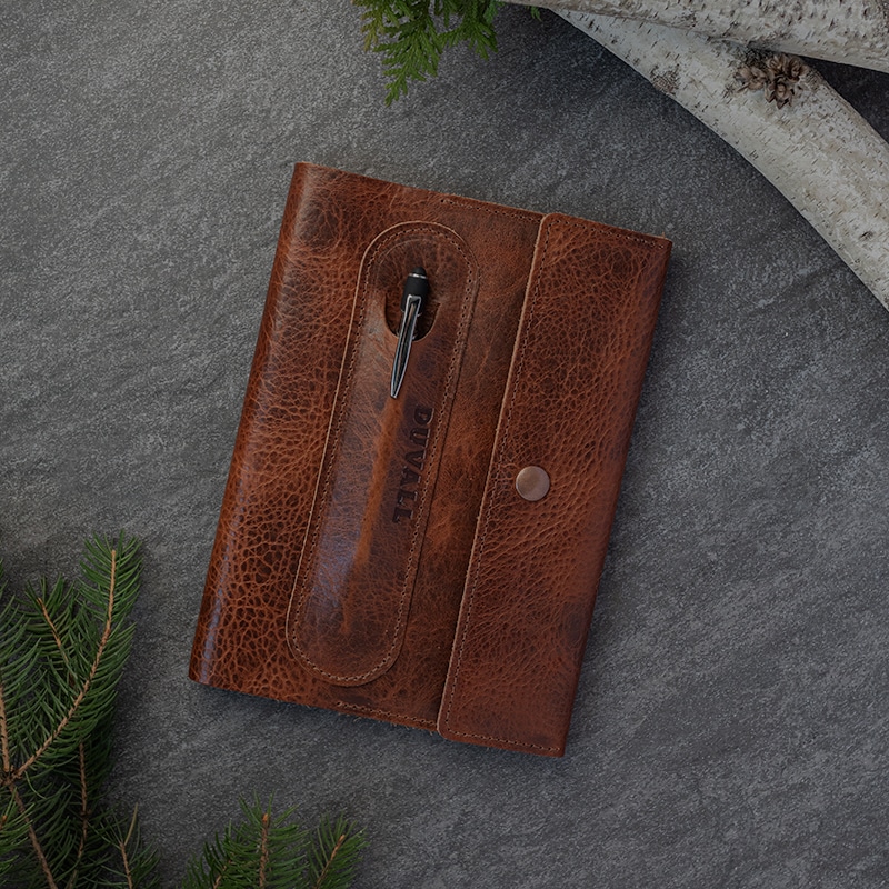 Brown bison leather journal cover on gray surface.