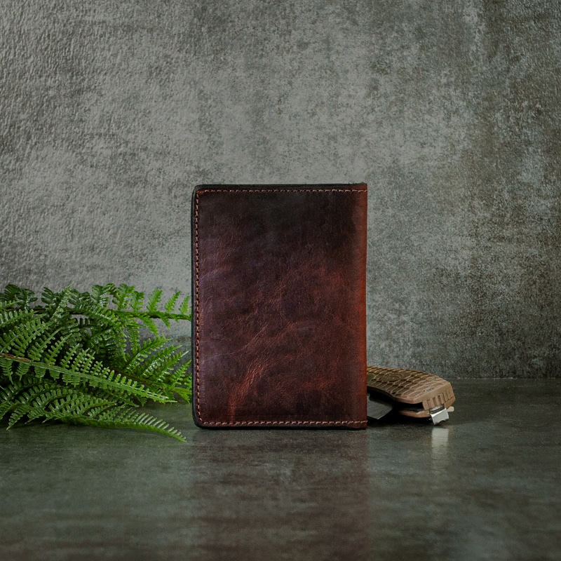The perfect size credit card wallet shot on a slate background with fern and pocket knife for your everyday needs that fits in your back pocket