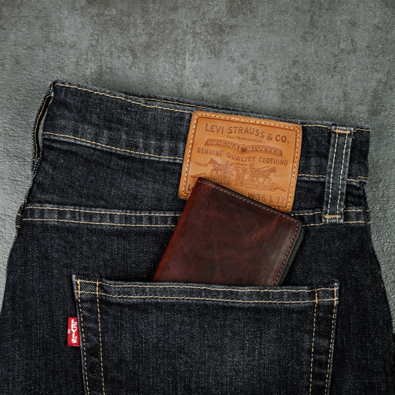 Great size credit card wallet that fits in your back pocket of any pants for easy usage shot on grey slate background.