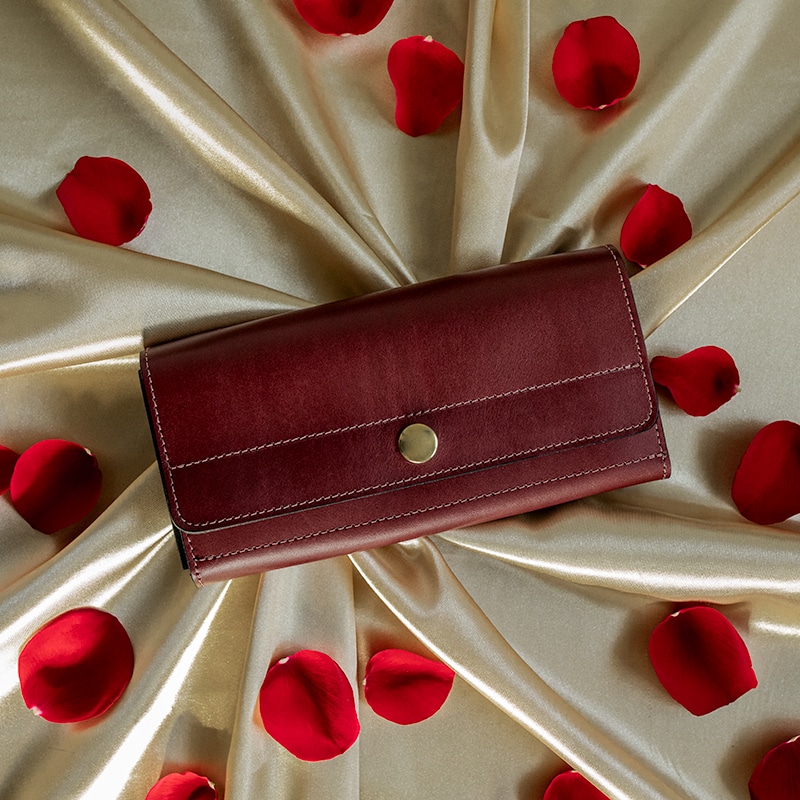 Women's wallet made from red leather that fits phone.