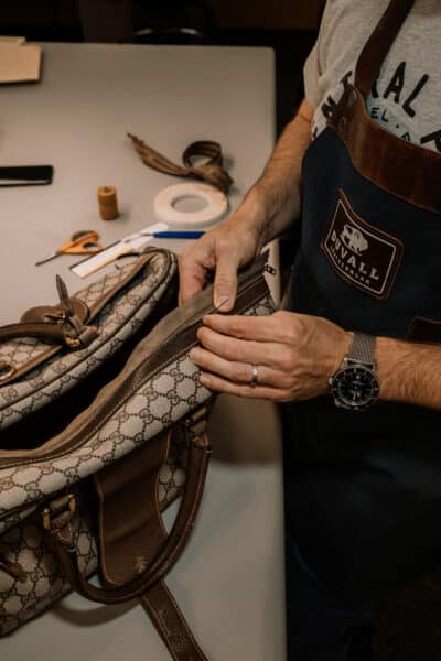 Repairing a zipper in a Gucci bag.