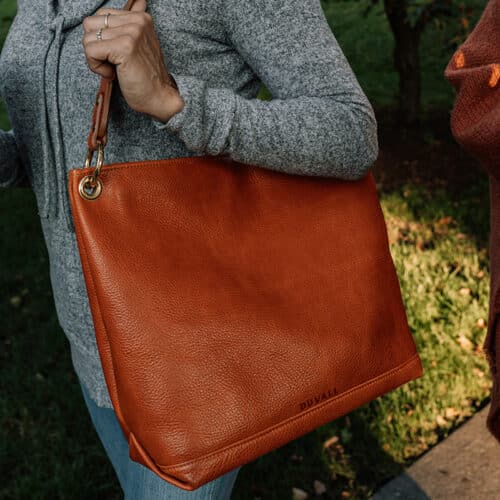 Orange slouchy bag on shoulder