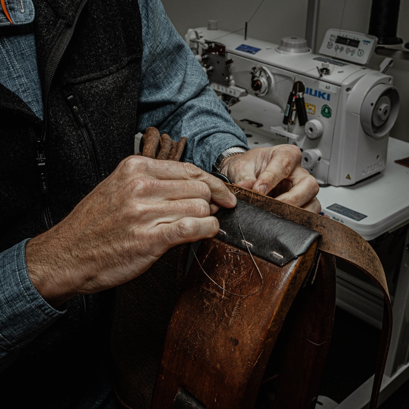 Hand sewing leather using a stitching horse