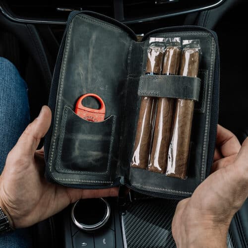 Inside of the Tobacco Leaf Cigar Case with cigars and cutter