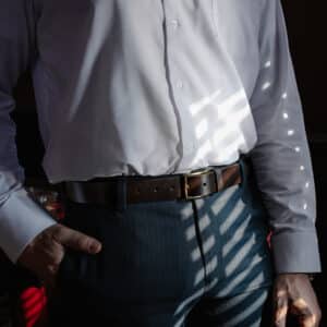 Man wearing a Full Grain, Dark Brown Leather Dress Belt with a Sleek, Brass Belt Buckle